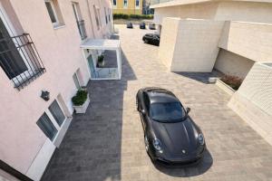 a black car parked in a parking lot next to a building at Greif Hotel & Spa in Trieste