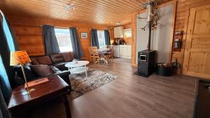 a living room with a couch and a stove at Bringnes Camp in Russenes +34 photos