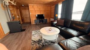 a living room with a couch and a table at Bringnes Camp in Russenes