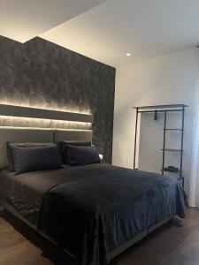 a bedroom with a large bed with a large headboard at Domus Europa in Matera