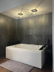 a large white bath tub in a bathroom at Domus Europa in Matera
