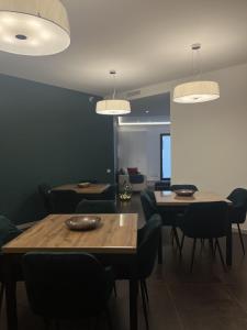 a dining room with tables and chairs and lights at Domus Europa in Matera