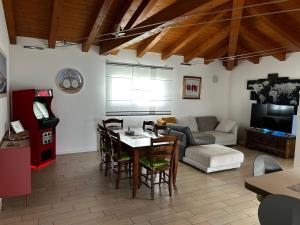 a living room with a table and a couch at Casa di Diego in Porpetto