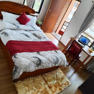 a bedroom with a bed and a table with a chair at North face Studio in Pokhara