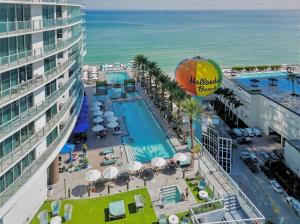 an aerial view of a resort with a pool and the ocean at LYFE Resort Ocean View Penthouse in Hollywood