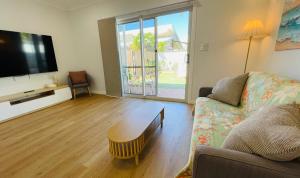 a living room with a couch and a coffee table at Sunrise Beach Hideaway in Exmouth