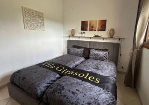 a bedroom with a bed with a christmas sign on it at Vila Girasoles in Cálig +14 photos