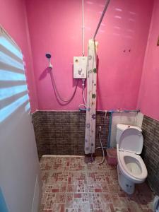 a pink bathroom with a toilet and a pink wall at Pink Hostel in Ko Tao +10 photos