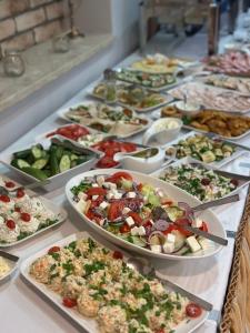 a buffet with many plates of food on a table at Sosnowe Zacisze in Białystok