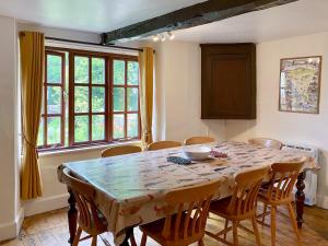 a dining room with a table with chairs and a window at Brook House 1 - Uk1415 in Bassenthwaite +27 photos