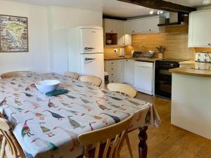 a kitchen with a table with a bird blanket on it at Brook House 1 - Uk1415 in Bassenthwaite