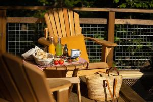 a chair and a table with bottles and a basket at Cabanyes entre Valls in Vall de Bianya +52 photos