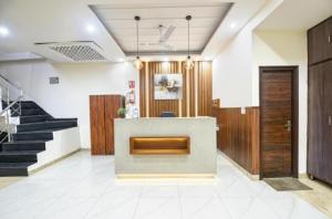 a lobby with a staircase and a reception desk at Hotel Red ark inn in Mohali