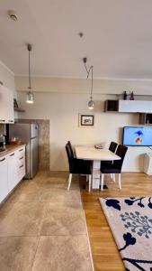 a kitchen and dining room with a table and chairs at Sea view apartment 2 in Boreti