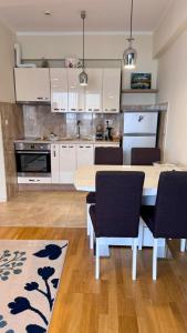 a kitchen with a table and chairs in a room at Sea view apartment 2 in Boreti +9 photos