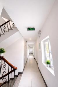 a hallway in a house with white walls and stairs at Pham Gia Hotel Mui Ne in Mui Ne +29 photos