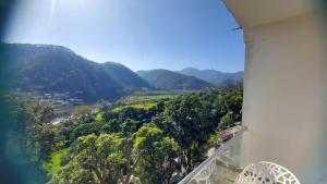 a view of a valley from a tower with mountains in the background at Nileshwar Home Stay in Bāgeshwar