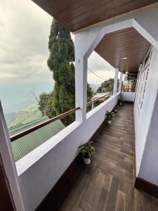 a room with a balcony with a view at P Square Resto Cafe n Stay in Darjeeling