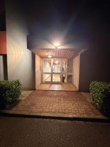 a building with a doorway with a light on it at Studio neuf élégant- calme & cosy in Oyonnax +6 photos