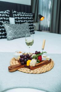 a plate of food and a glass of wine on a table at Tlou Luxe stay in Gaborone
