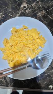 a plate with a pile of food and a fork and spoon at Mulei homestay in Wainapal