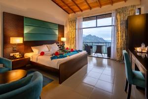 a hotel room with a bed and a large window at The Pinnacle Ella Boutique Hotel and Spa in Ella