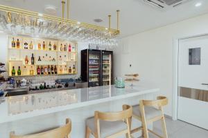 a bar with two chairs and a counter at Hotel ORJEN sport & pleasure in Trebinje