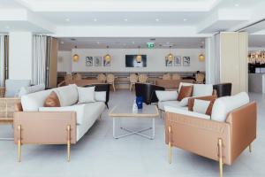 a living room with two couches and a table at Hotel ORJEN sport & pleasure in Trebinje