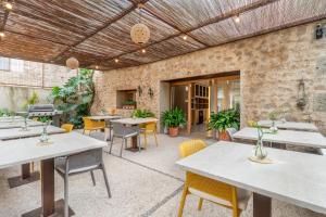 an outdoor patio with tables and chairs at Finca Sestelrica in Artá