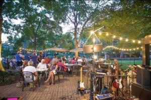 a group of people sitting at tables in a park at The Old Lyme Inn in Old Lyme