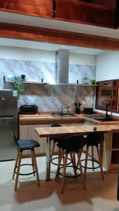 a kitchen with a wooden table and two chairs at El Estuario Niebla Cabin in Niebla