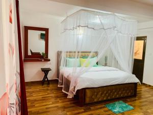 a bedroom with a canopy bed with a mirror at Happy Rest House Ella in Ella +74 photos