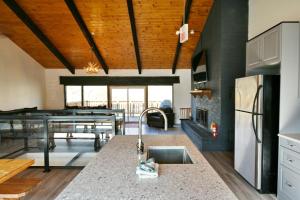 a kitchen and living room with a sink and a table at chalet in blue mountain in Blue Mountains