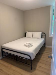 a bed in a room with two towels on it at chalet in blue mountain in Blue Mountains