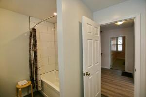a bathroom with a shower and a bath tub at chalet in blue mountain in Blue Mountains +36 photos