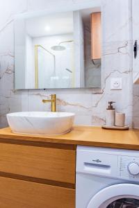 a bathroom with a sink and a washing machine at Studio Élégant - Proche Paris & La Défense in Rueil-Malmaison +22 photos