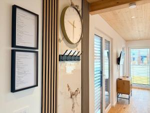 a large clock on a wall in a room at Chalet du calme Gersthofen in Gersthofen