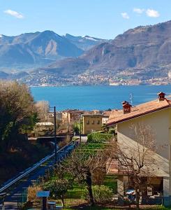 a view of a city and the water with mountains at Casa Fiocco vista Lago in Pisogne +74 photos