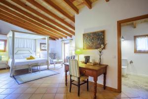 a bedroom with a desk and a bedroom with a bed at Boutique Hotel Sa Galera in Caʼs Concos +66 photos