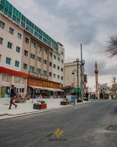a man walking down a street next to a building at Hotel RABİS in Urfa