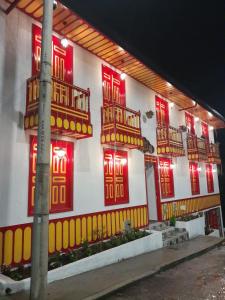 a building with red and yellow doors and windows at La Casa De Mi Tatis in Salento