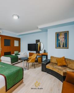 a hotel room with a bed and a couch at Hotel RABİS in Urfa