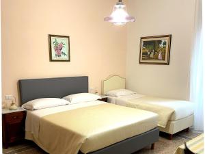 a hotel room with two beds in a room at Casa Obìa in Cagliari