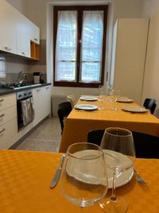 a kitchen with two tables with wine glasses on it at Casa Obìa in Cagliari