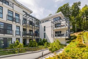 an apartment building with balconies and trees at Villa Louisa - Wohnung 36 in Ostseebad Sellin