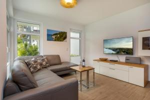 a living room with a couch and a table at Villa Louisa - Wohnung 36 in Ostseebad Sellin