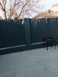 a black fence with a bench next to it at Focsani Casa cris in Focşani