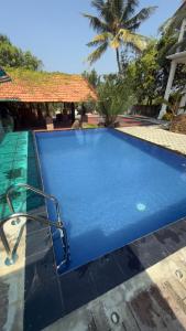 a large blue swimming pool in a resort at SeekRide Bolgoda in Bandaragama