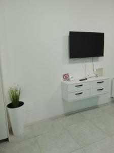 a living room with a tv on a white wall at Focsani Casa cris in Focşani