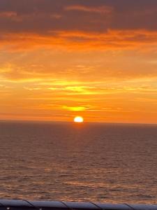 a sunset over the ocean with the sun in the sky at Oomes Huus - Sleep by Hästens, Wake with Coffee in Den Hoorn +257 photos